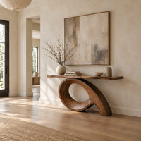 Narrow console table with a live edge top on a sweeping looped base in a bright open plan entryway