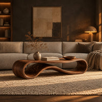 Coffee table with a flat top over a looping wave shaped wooden base in a dark living room at golden hour
