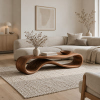 Coffee table with a flat top over a looping wave shaped wooden base in a Scandinavian living room with white walls