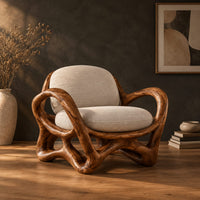 Wooden chair with a looping ribbon frame and an interlaced base in a dark studio against a charcoal plaster wall