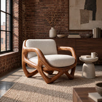 Armchair with a looped sculpted wood frame and a cushioned seat in an industrial loft living room with exposed brick