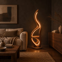 Flame shaped floor lamp with glowing loops and a small flat ledge in a dark living room at golden hour