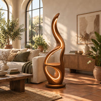 Flame shaped floor lamp with glowing loops and a small flat ledge in a bright living room with arched windows and plants
