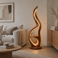 Flame shaped floor lamp with glowing loops and a small flat ledge in a Scandinavian living room with white walls