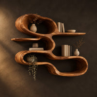 Wall shelf shaped as one looping ribbon of wood with open tiers in a dark studio against a charcoal plaster wall
