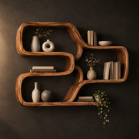 Wall shelf made from one looping ribbon of wood with open cells in a dark studio against a charcoal plaster wall
