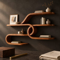 Corner detail of looping ribbon wall shelves joined by a central spiral coil beside wood, brass and linen samples
