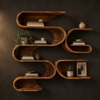 Looping ribbon wall shelves with interlocking pockets in a dark studio against a charcoal plaster wall