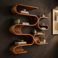 Looping ribbon wall shelves with interlocking pockets, three-quarter view showing the grain