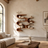 Looping ribbon wall shelves with interlocking pockets in a bright open plan living room