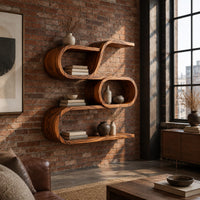 Looping wooden wall shelves with a middle oval cell and curled ends in an industrial loft living room with exposed brick