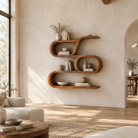 Looping wooden wall shelves with a middle oval cell and curled ends in a bright open plan living room