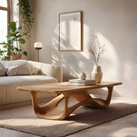 Looping wave base coffee table with pale top in a sunlit room with large windows and plants