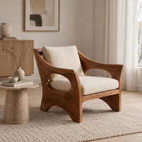 Lounge chair with oval side cutouts and an arched wooden base in a Scandinavian living room with white walls