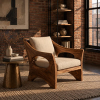 Lounge chair with oval side cutouts and an arched wooden base in an industrial loft living room with exposed brick