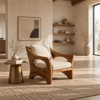 Lounge chair with oval side cutouts and an arched wooden base in a bright open plan living room
