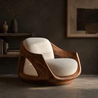 Lounge chair with a sculpted wooden shell and cream seat cushion, three-quarter view showing the grain
