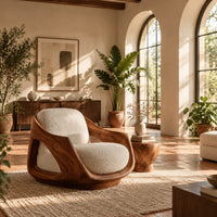 Lounge chair with a sculpted wooden shell and cream seat cushion in a bright living room with arched windows and plants