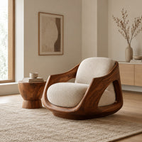Lounge chair with a sculpted wooden shell and cream seat cushion in a Scandinavian living room with white walls
