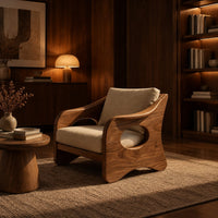 Lounge chair with oval side cutouts and tan cushions in an evening living room with walnut wall paneling