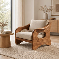 Lounge chair with oval side cutouts and tan cushions in a Scandinavian living room with white walls
