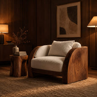 Lounge chair with wide solid wood arm panels and a cushioned seat in an evening living room with walnut wall paneling