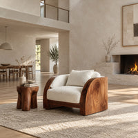 Lounge chair with wide solid wood arm panels and a cushioned seat in a bright open plan living room