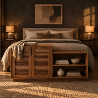 Stepped low cabinet with two louvered doors and an open shelf section in a dark bedroom at golden hour
