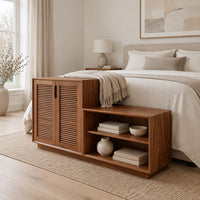 Stepped low cabinet with two louvered doors and an open shelf section in a Scandinavian bedroom with white walls