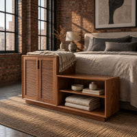 Stepped low cabinet with two louvered doors and an open shelf section in an industrial loft bedroom with exposed brick