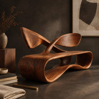 Corner detail of low wooden bench with a looping oval body and a crossed ribbon backrest beside wood, brass and linen samples