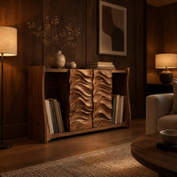 Low bookshelf with two carved wave doors and open bays at both ends in an evening living room with walnut wall paneling