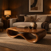 Low oval wooden coffee table with a folded ribbon body in an evening living room with walnut wall paneling