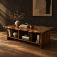 Low coffee table with a wavy natural edge top and three open cubbies, three-quarter view showing the grain