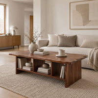 Low coffee table with a wavy natural edge top and three open cubbies in a Scandinavian living room with white walls
