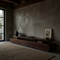 Low drawer plinth TV stand with a floating shelf in a concrete and timber loft