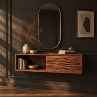 Floating makeup vanity with an open cubby and a wave carved front panel, three-quarter view showing the grain
