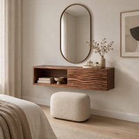 Floating makeup vanity with an open cubby and a wave carved front panel in a Scandinavian bedroom with white walls