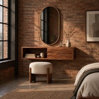 Floating makeup vanity with an open cubby and a wave carved front panel in an industrial loft bedroom with exposed brick