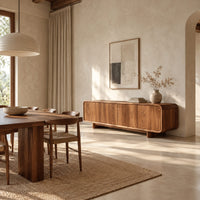 Low wood sideboard with four flat front panels and short legs in a bright open plan dining room