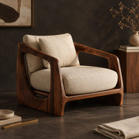 Corner detail of low wooden chair with open arms and oval cutouts in the sides beside wood, brass and linen samples