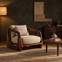 Low wooden chair with open arms and oval cutouts in the sides in a dark living room at golden hour