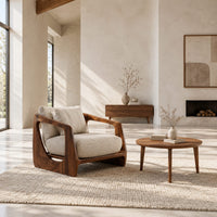 Low wooden chair with open arms and oval cutouts in the sides in a bright open plan living room