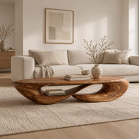 Low oval coffee table on a twisted open loop base in a Scandinavian living room with white walls