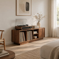 Low wood record console with three open cubbies and a panel end in a Scandinavian living room with white walls