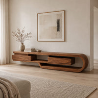 Low tv stand shaped like a looping wood ribbon with two boxed front sections in a Scandinavian living room with white walls