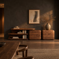 Low sideboard with an open shelf bay and two block cabinets in a dark dining room at golden hour