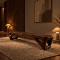 Low slab top bench with open triangular legs in an evening entryway with walnut wall paneling