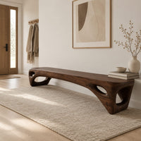 Low slab top bench with open triangular legs in a Scandinavian entryway with white walls