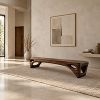 Low slab top bench with open triangular legs in a bright open plan entryway